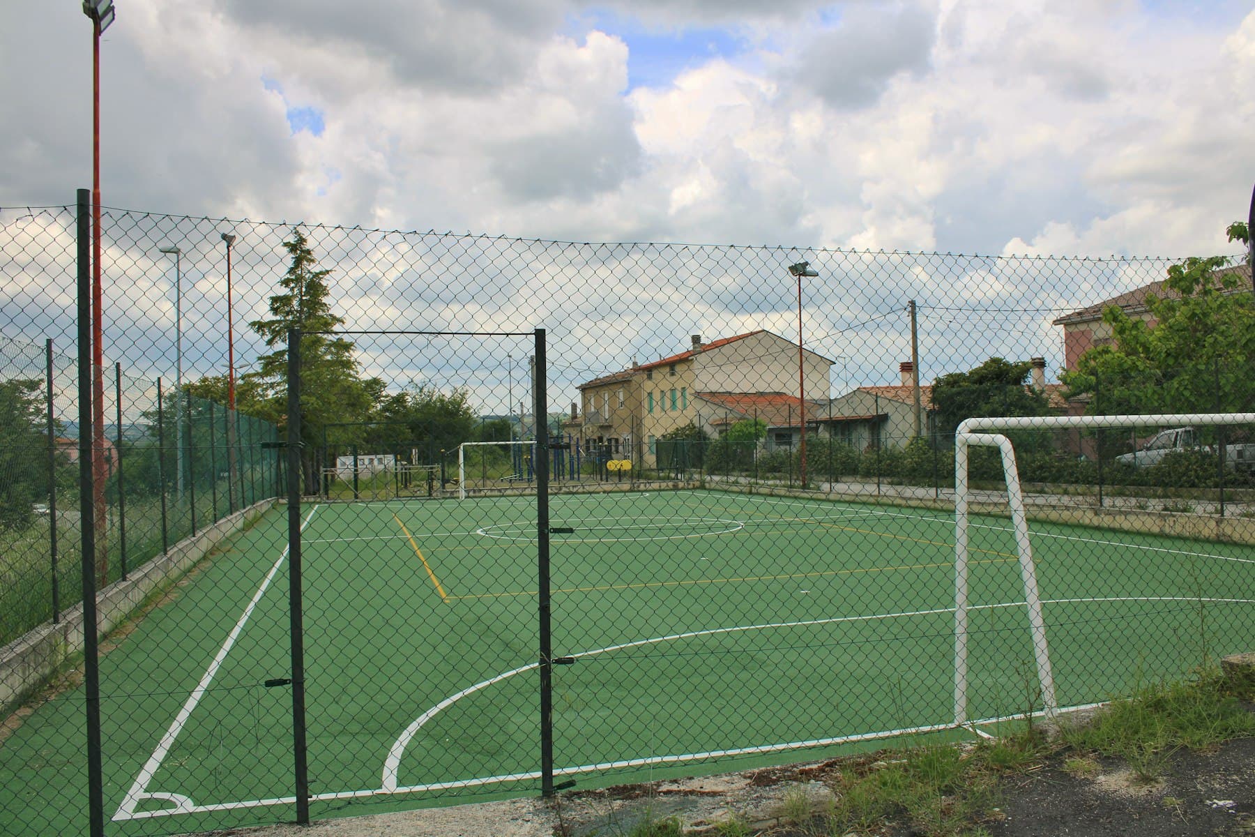 Campo desportivo vedado, com redes de proteção e balizas